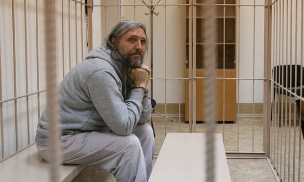 Sergei Torop sits in a cell at Novosibirsk central district court