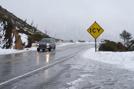 An SUV drives through the icy pass in the San Gabriel Mountains in California.
