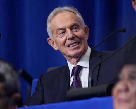 In a dark suit and wearing a purple tie, Tony Blair attends a meeting of Donald Trump's Board of Peace