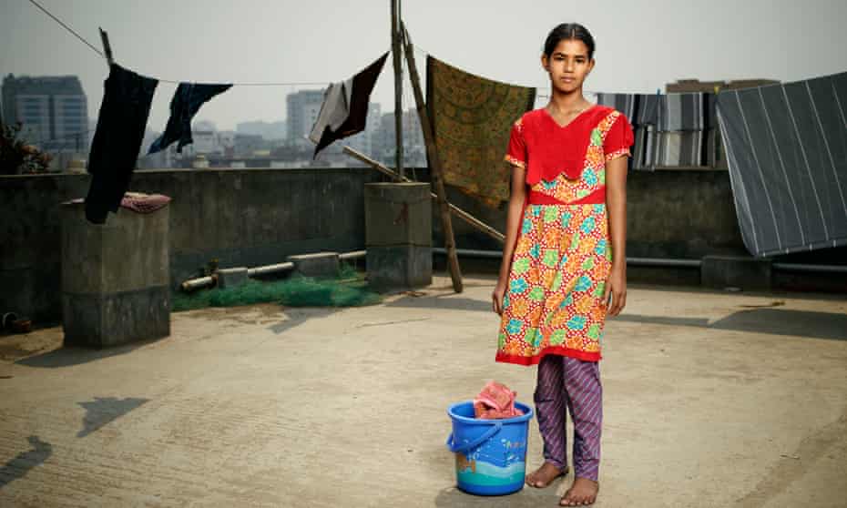 Girl stands on rooftop with washing