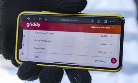 DeAndré Upshaw shows a $5,000 bill from Griddy on his cellphone for his 900 sq ft apartment during very cold weather in Dallas, last Friday.