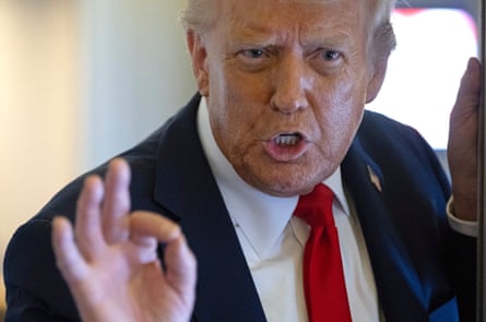 a man in a suit speaks in a plane