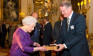 The Queen is presented with a specially commissioned participation medal by the chairman of World Rugby, Bernard Lapasset.