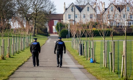 Police officers walk through Stanley Park in Liverpool