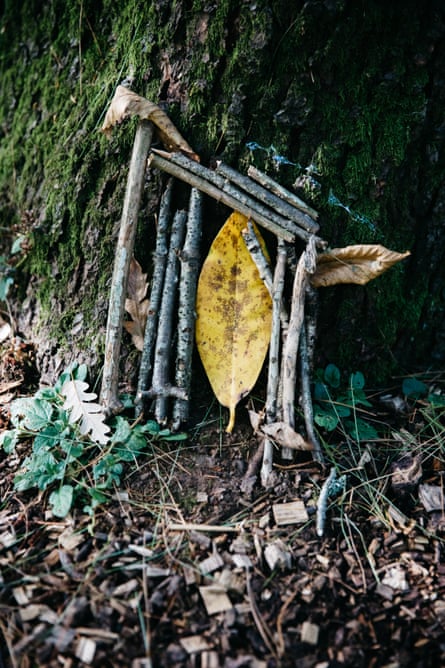 A small tree sculpture or fairy door built by a visitor at the base of a tree at Westonbirt
