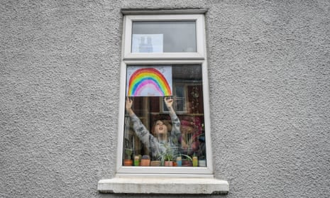 Child taping picture of rainbow to window