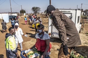 Ubuntu Project team members distribute parcels of fresh vegetables to residents of Esilahliwe