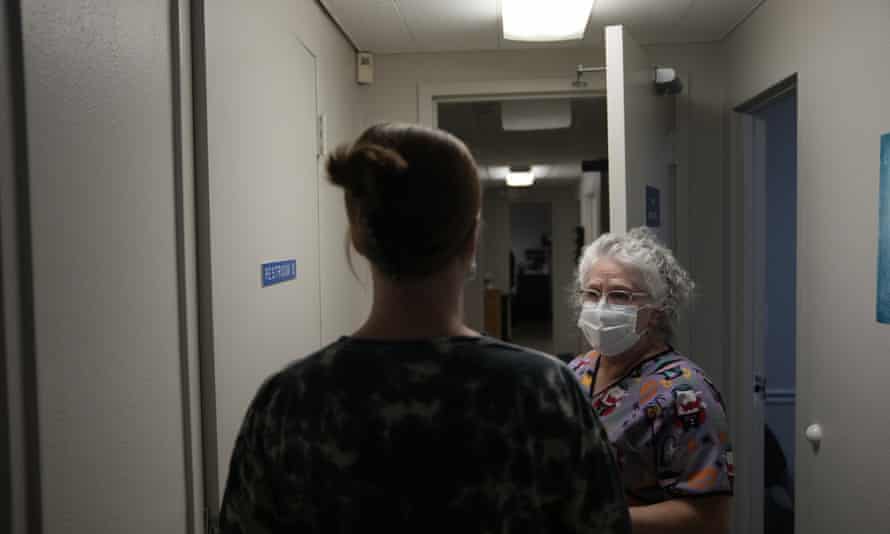 A 25-year-old woman from Texarkana, Texas is being led by lab technician Stephannie Chaffee on Saturday in Shreveport, Louisiana.