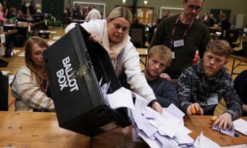 An election official empties a ballot box in Blackpool
