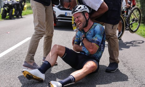Mark Cavendish receives medical attention after his crash.