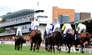 Racegoers watch from the grandstand at Fontwell, where a jumps fixture takes place on Thursday.