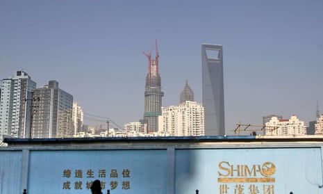 A man walks past a Shimao building site in Shanghai.  