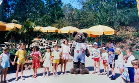 A young Sophie Black holds the hand of Dreamworld’s koala mascot.