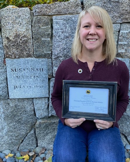 Lindsay Perodeau at the Proctor’s Ledge memorial in Salem, dedicated to her ancestor, Susannah Martin. She is holding her ‘Daughter of a Witch’ certificate.