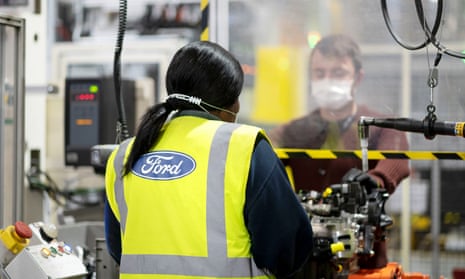 Workers wearing masks and separated by a screen at Ford’s Dagenham Engine Plant in Essex.