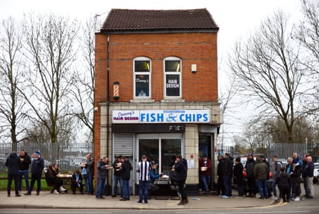 Fans queue at the Maine Road Chippy before the match