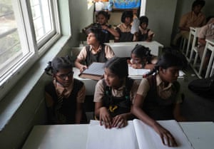 Students with visual disabilities read books in braille at the Devnar school for the blind in Hyderabad, India