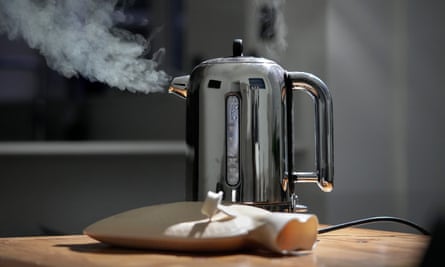 Electric kettle emits steam and vapour next to a hot water bottle