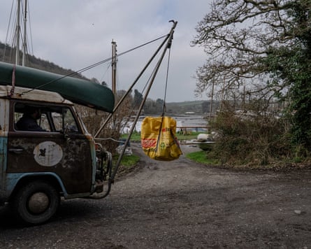 An old VW van lifts bags of plastic after they have been weighed.