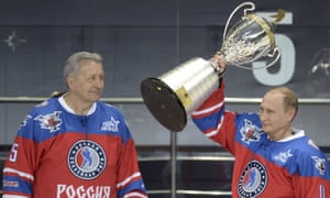 Vladimir Putin lifts a trophy