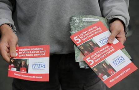 A person holding leaflets with the words ‘5 positive reasons to take back control’.
