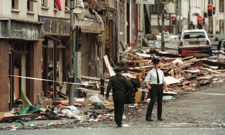 Police stand amid the rubble of the Omagh bombing