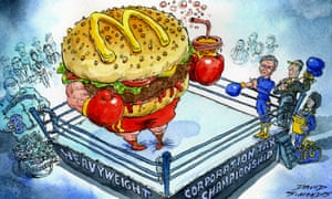 Cartoon of McDonald's hamburger wearing boxing gloves in a boxing ring.