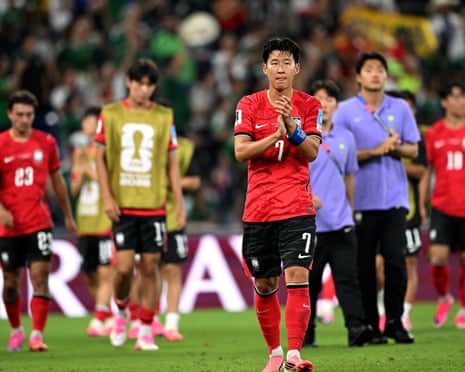 A dejected Son Heung-min claps at the end of a World Cup game with South Korea.