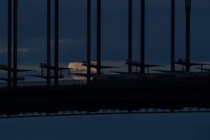Moon rises behind the Sydney Harbour bridge