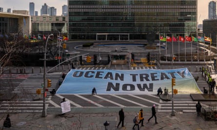 Activists from Greenpeace unfurl banner
