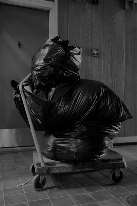Garbage bags stuffed full on a hand cart. immersive-3-up