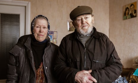 An elderly couple pose for a photo after shelling. Only 2000 civilians remain in Avdiivka, down from a pre-war population of 30,000.