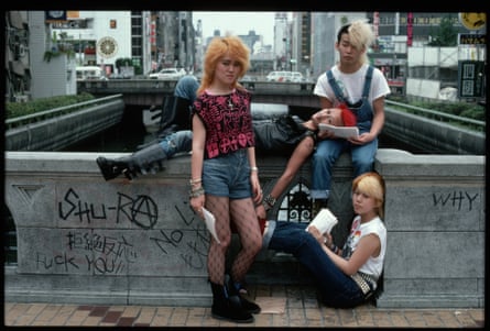 Punks, with heavily dyed and styled hair, sit on a graffiti-covered bridge in Osaka. (Photo by Roger Ressmeyer/Corbis/VCG via Getty Images)