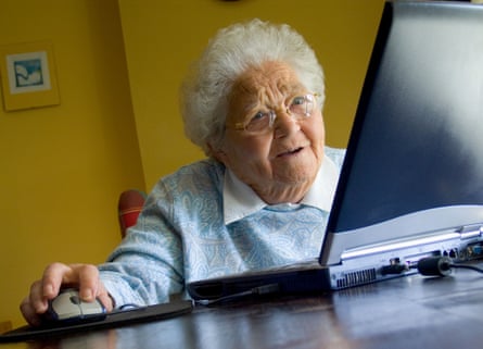 An older woman uses her laptop computer at home