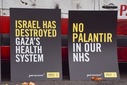 Signs that say ‘Israel has destroyed Gaza’s health system’ and ‘No Palantir in our NHS’