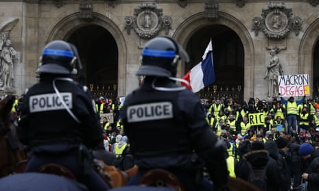 French mounted police stand in front of gilets jaunes protesters outside the Opera House in Paris.