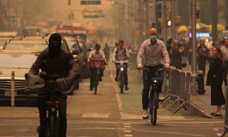 Haze and smoke caused by wildfires in Canada blanket New York City. People ride bicycles at 6th Avenue as haze and smoke caused by wildfires in Canada blanket New York City, New York, U.S., June 7, 2023.