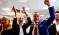 Tino Chrupalla and Alice Weidel raise hands in air