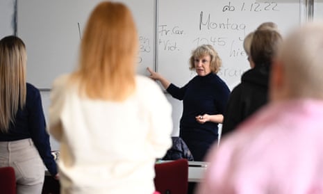 German teacher gives a German language lesson to Ukrainian women refugees in Berlin, Germany.
