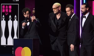 The 1975 accept the Brit award for best alternative rock act.