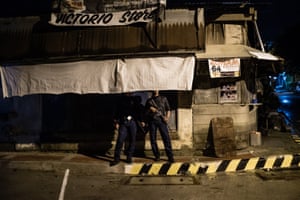 A police officer on a routine patrol in Manila. It is claimed that some police are secretly involved in extra-judicial killings.