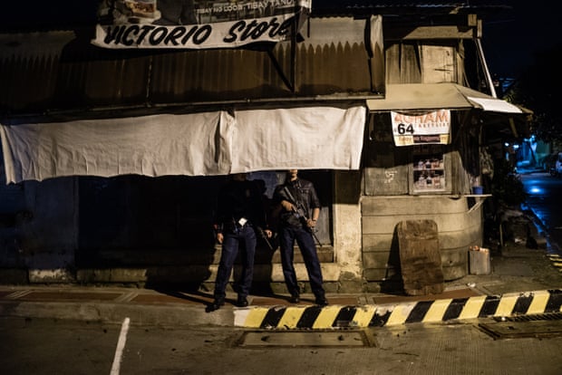 A police officer on a routine patrol in Manila. It is claimed that some police are secretly involved in extra-judicial killings.