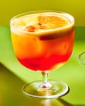 An Aperol garibaldi. It is orange. It is served in a cocktail bowl or stemmed old fashioned glass.