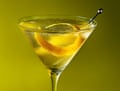 The Millionaire’s vodkatini and a peel of lemon in a martini glass.