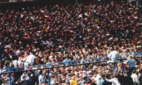 Fans climb over fences to escape the crush at the 1989 FA Cup semi-final at Sheffield Wednesday’s Hillsborough ground