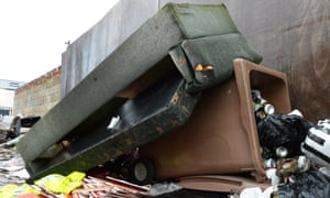 A fly-tipped sofa at a rubbish dump