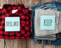 Two piles of clothes – one marked discard, the other marked keep