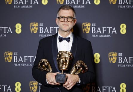 Paul Thomas Anderson with his awards for best film, best adapted screenplay, and best director for One Battle After Another.