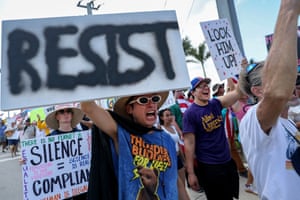 a person holds a sign that read ‘resist’