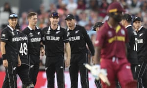 New Zealand cricketers celebrate the wicket of West Indies’ Kemar Roach.